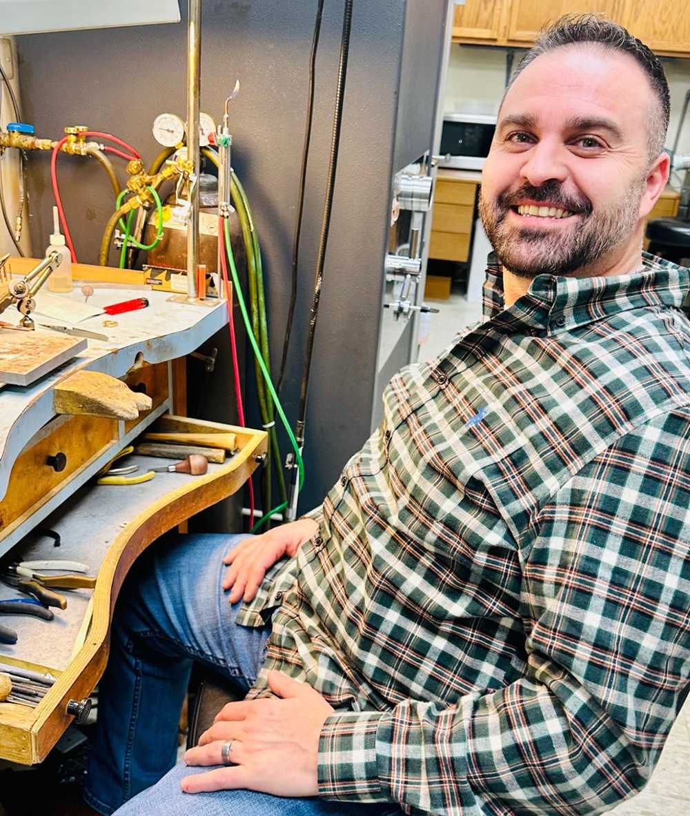 Photo of Leon at his work bench for designing and repairing custom jewelry in southeast Michigan